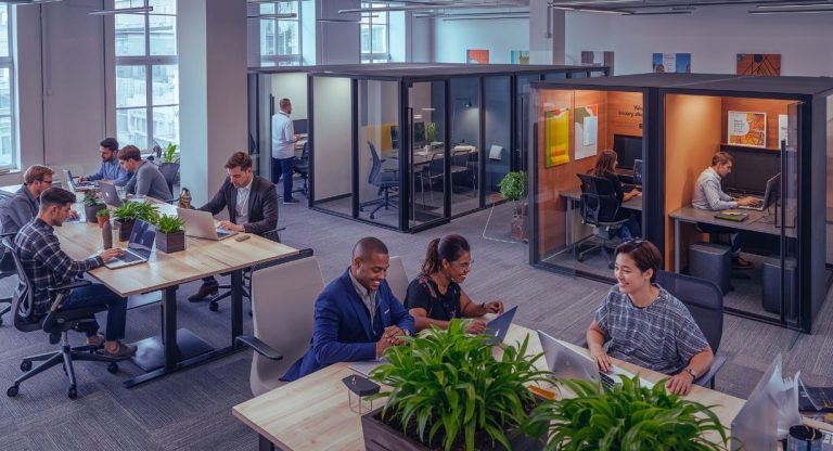 Vue aérienne d'un open space moderne avec des professionnels travaillant sur ordinateur portable