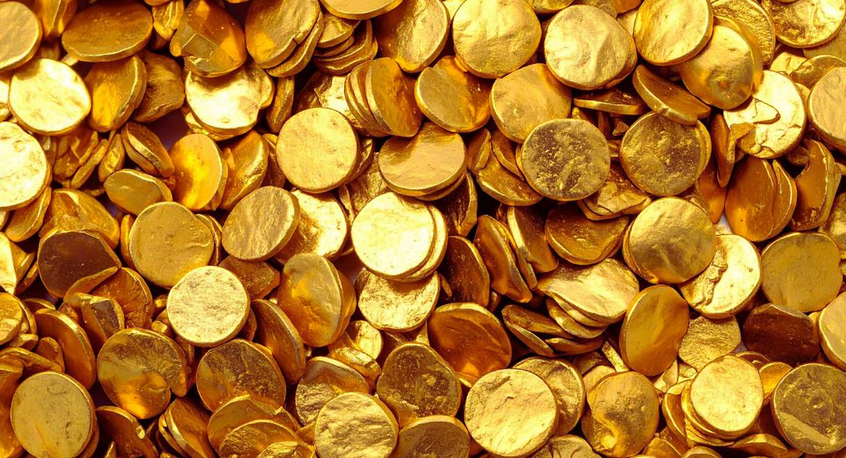Multitude de pieces d'or empilees evoquant un tresor et la monnaie de collection
